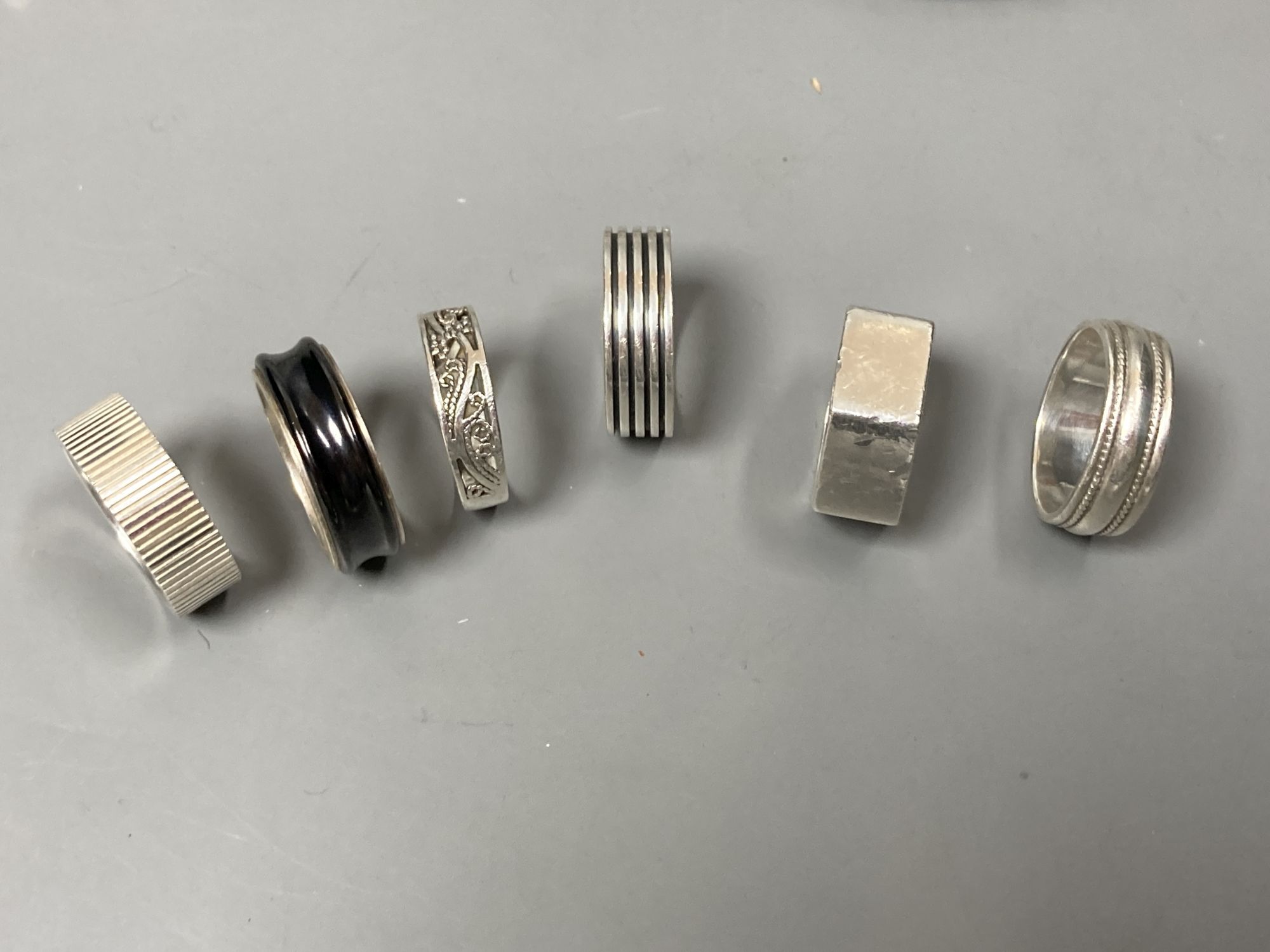 Two white metal bangles, one stamped Tiffany & Co with similar ring, five 925 rings, and a 925 bracelet.